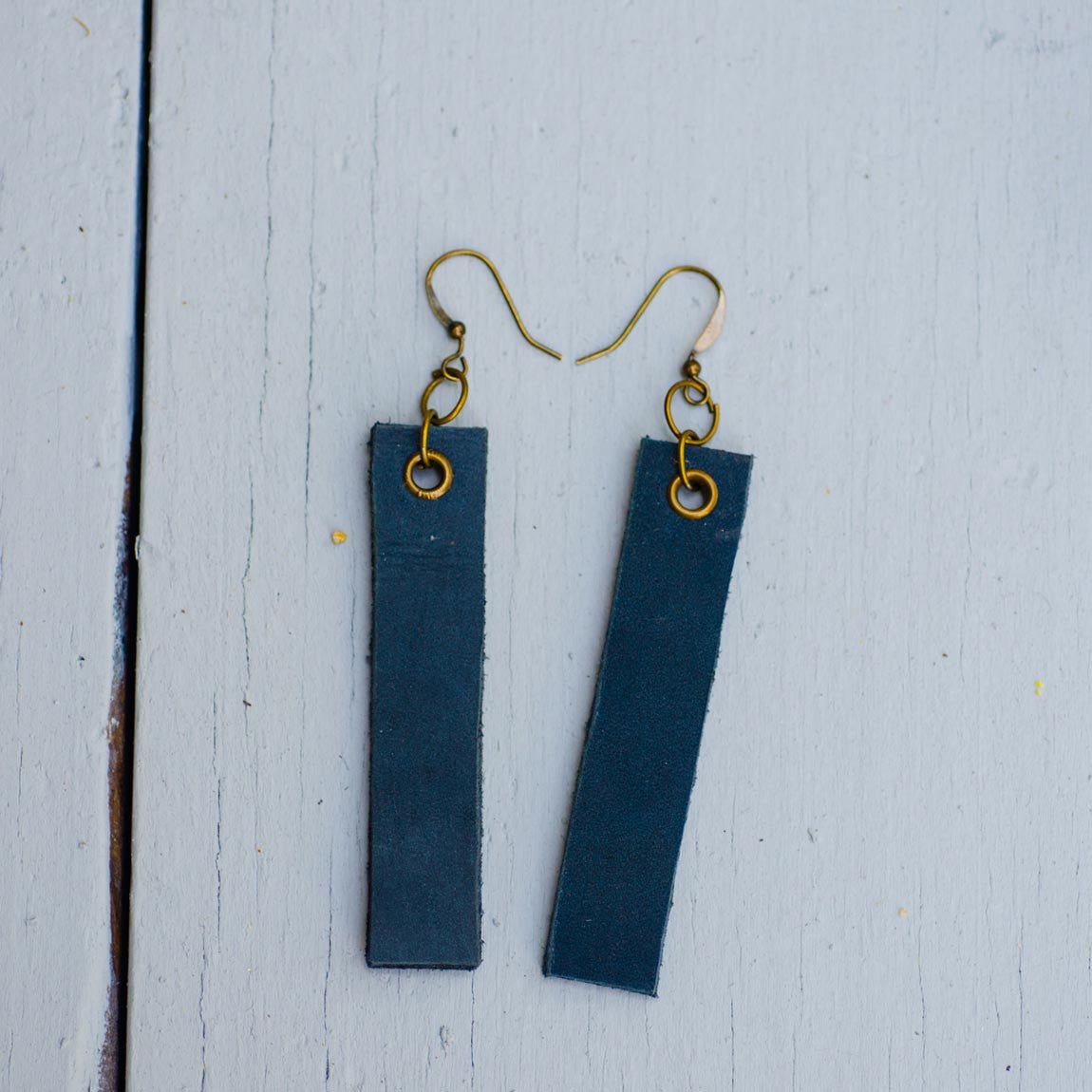 navy blue minimalist rectangular leather earrings front top view