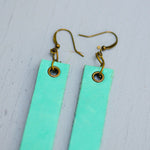 mint colored minimalist rectangular leather earrings with antique details