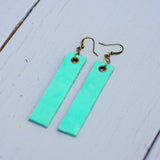 mint colored minimalist rectangular leather earrings with antique hooks, side view