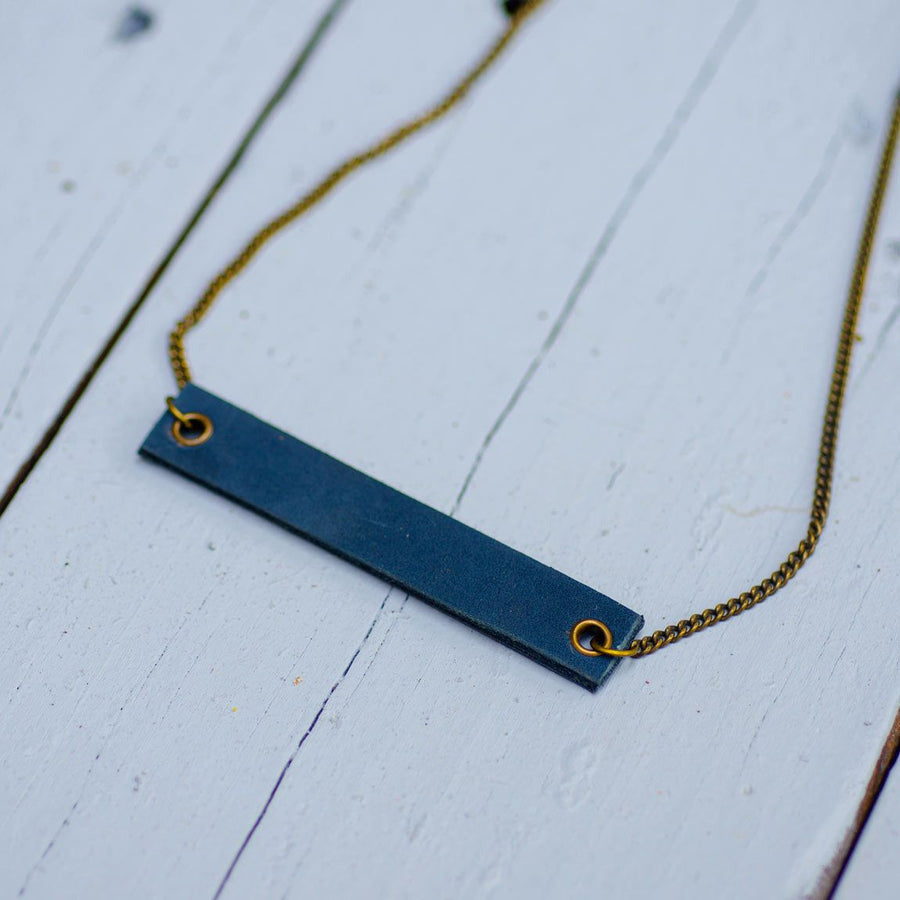 navy blue minimalist rectangular leather neck piece with antique chain
