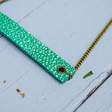 sea green minimalist rectangular neck piece with antique details